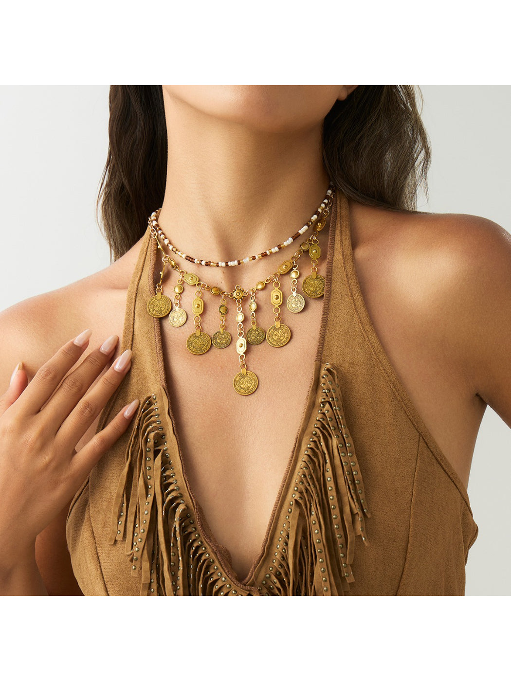 Boho coin pendant necklace worn on a model's neck with casual outfit