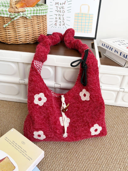 Cosbai floral knit drawstring bag worn over shoulder with casual outfit
