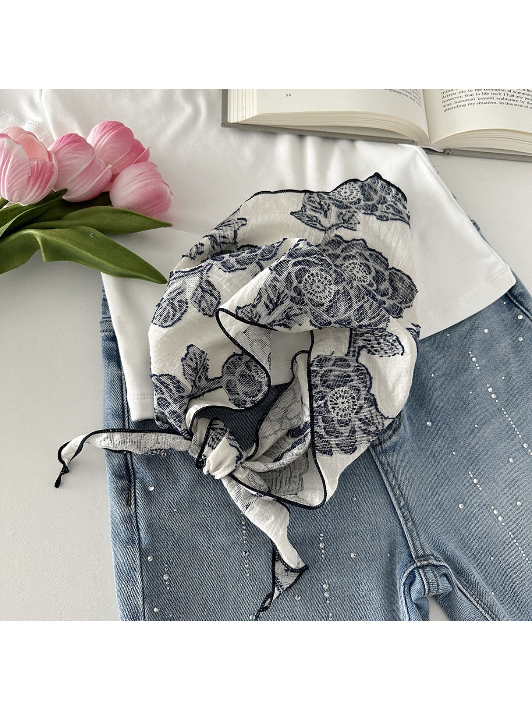 Scarvii neck scarf folded to display lace pattern and smooth fabric finish
