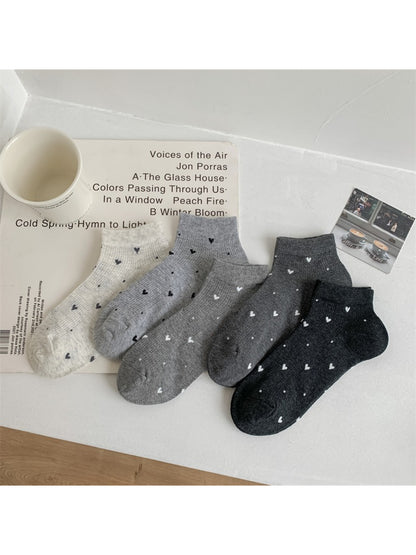 Pair of Rufia ankle socks in light beige with small red heart pattern detail