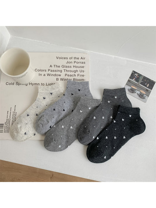 Pair of Rufia ankle socks in light beige with small red heart pattern detail