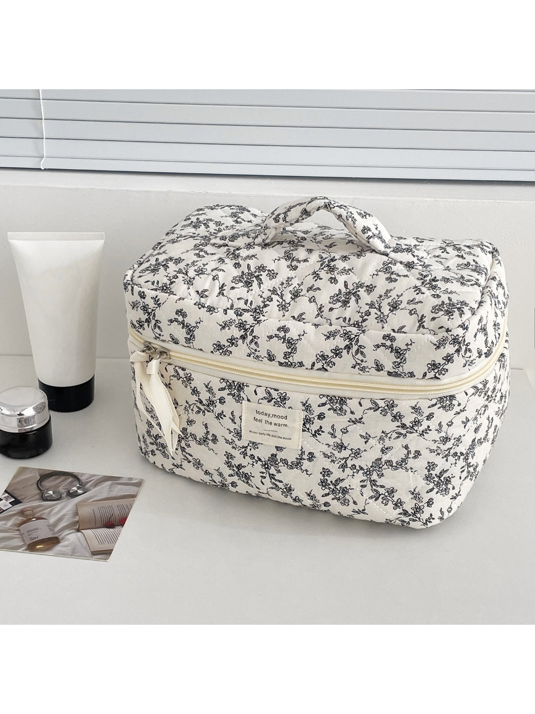 Close-up of floral quilted pattern and details on Cosbai makeup train case
