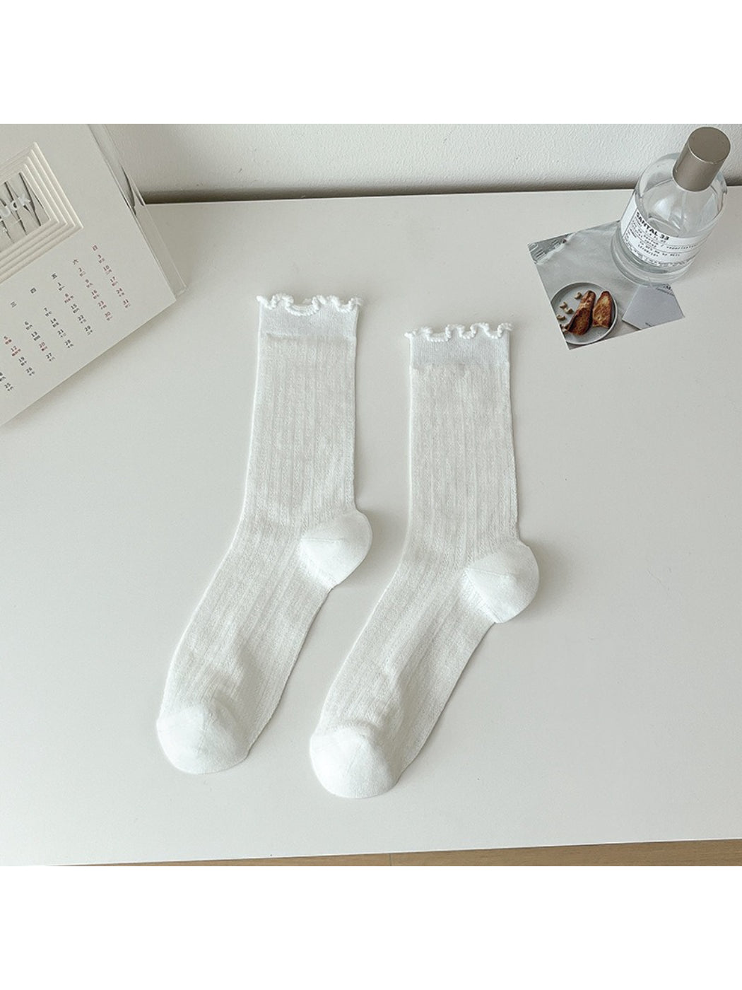 Side view of Rufia lace white mid-calf socks highlighting lace texture