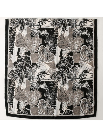 Floral scarf spread flat to show the repeated flower pattern and black border