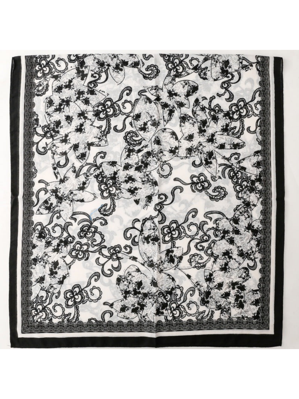 Floral scarf spread flat to display the overall print and contrasting border