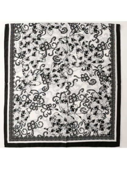 Floral scarf spread flat to display the overall print and contrasting border