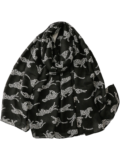 Black scarf with white leopard silhouettes, loosely looped