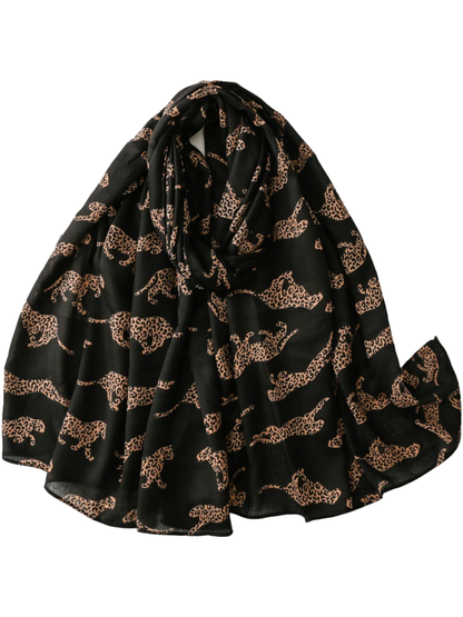 Camel leopard silhouettes on a black scarf, loosely looped