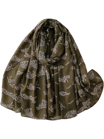Green scarf with repeating leopard silhouettes, loosely looped