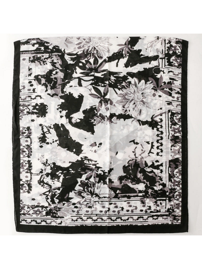 Black, gray and white floral and abstract print scarf spread flat with a broad black border