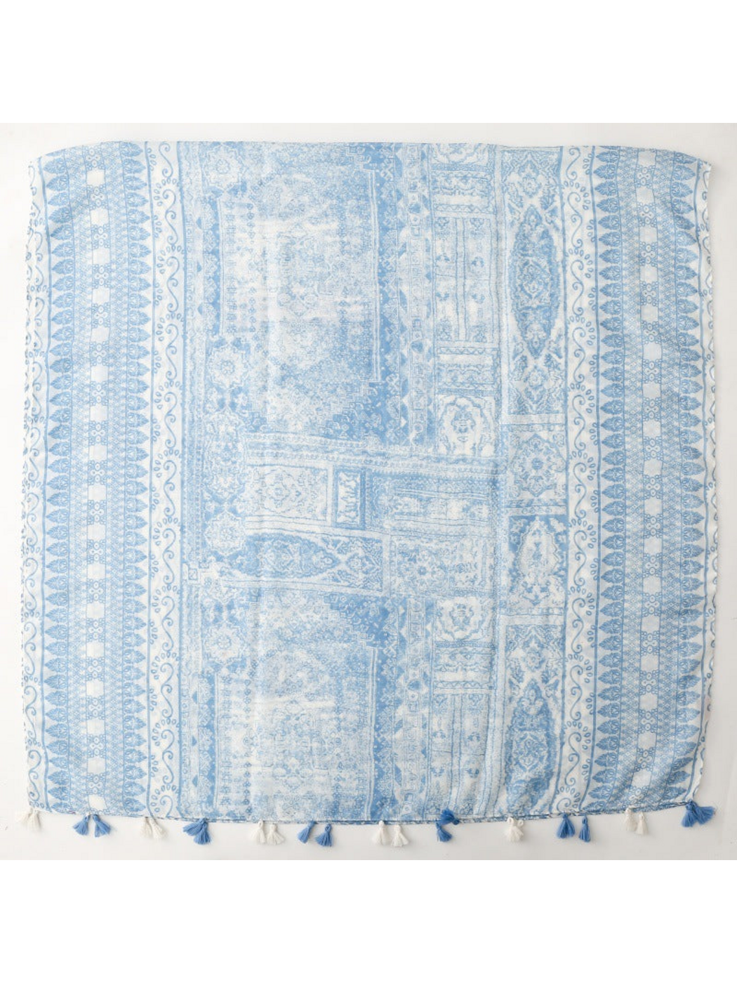 Blue and white scarf spread flat with ornamental panels, patterned borders and tassels
