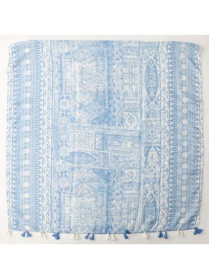 Blue and white scarf spread flat with ornamental panels, patterned borders and tassels