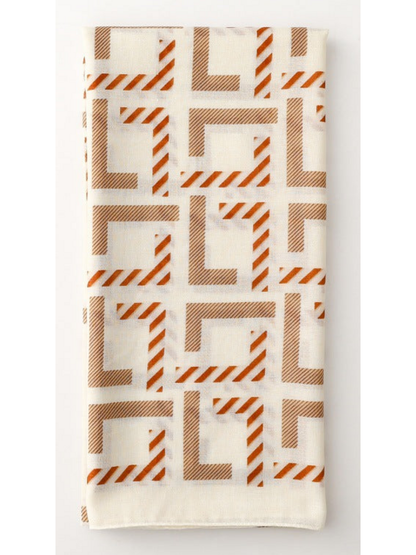 Geometric scarf folded lengthwise with repeating angular motifs
