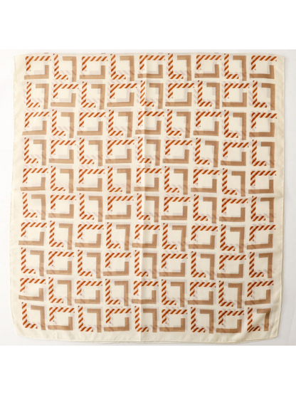 Scarf spread flat to display its repeating angular pattern and plain border