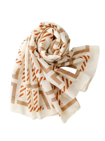 Geometric scarf arranged in a compact coil with overlapping ends