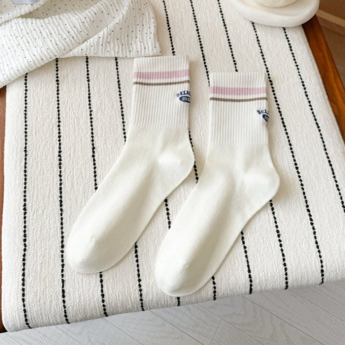 Rufia Retro Stripe Letter Crew Socks packaging with socks partially visible inside