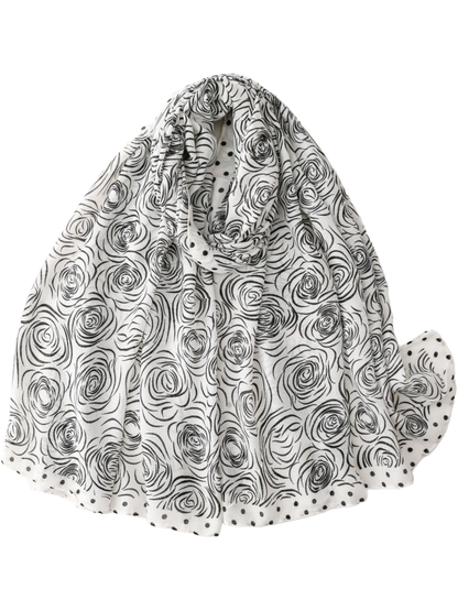 White scarf with black rose motifs and a polka dot border, looped display