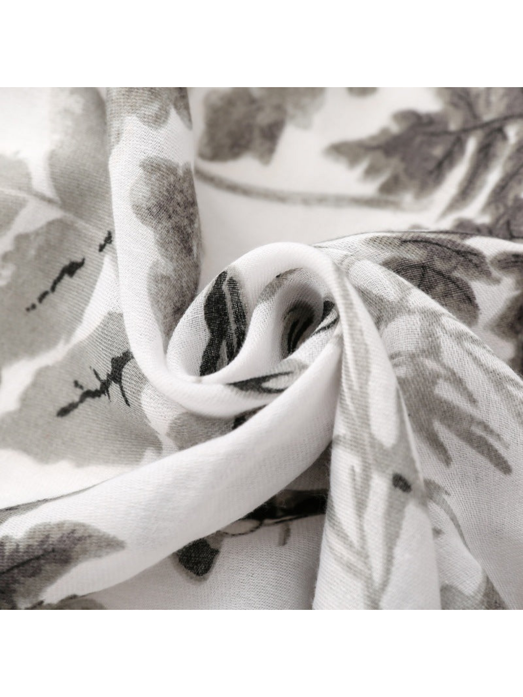 Close-up of Gray botanical print scarf showing fine woven texture and curled folds