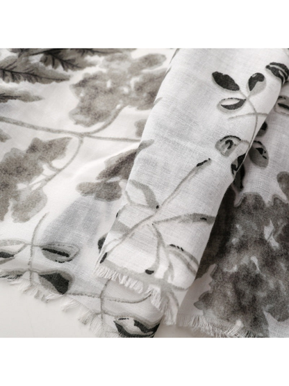 Close-up of Gray botanical print scarf with short fringed edges