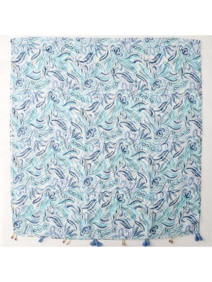 Blue scarf spread flat, showing the overall floral and leaf pattern and decorative edge trim