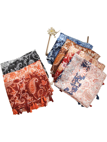 Folded paisley and floral scarves displayed in six color combinations