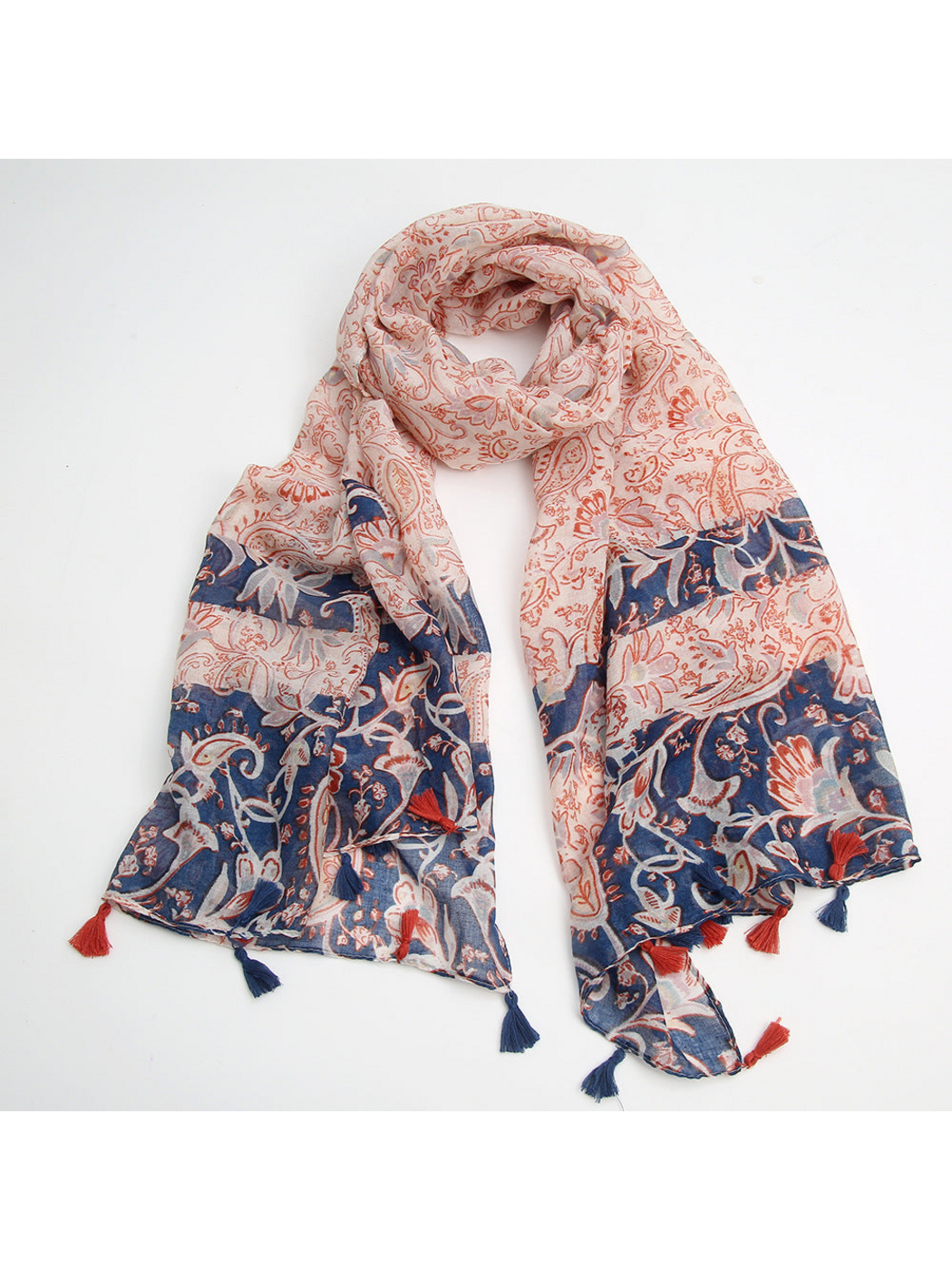 Paisley and floral scarf with navy panels and tassels arranged on white