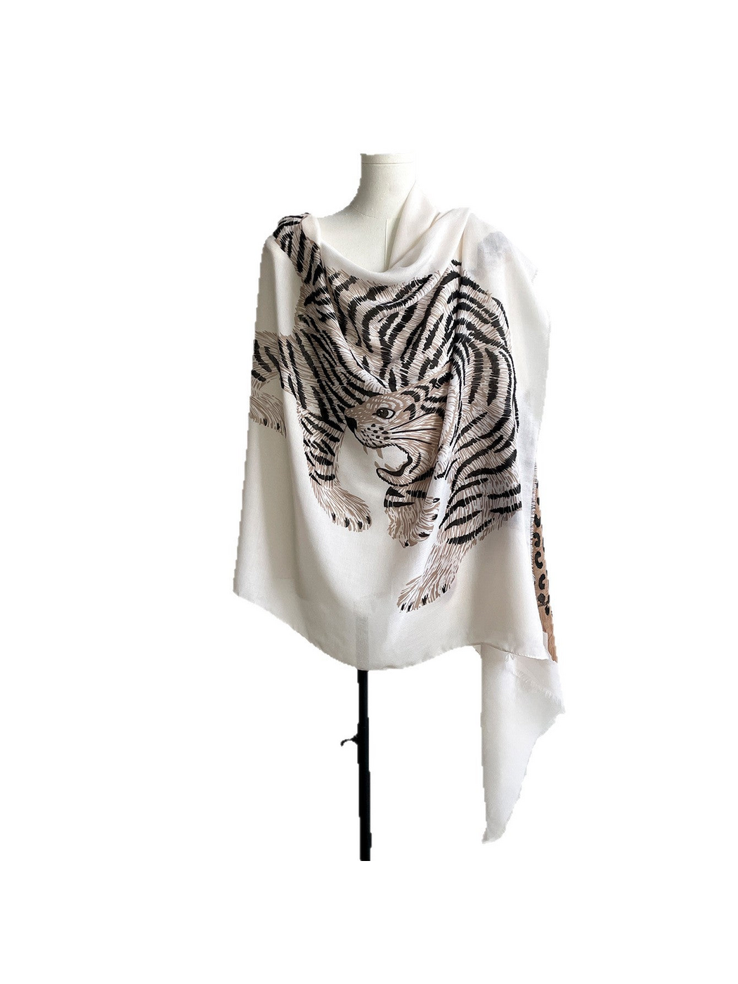 White scarf draped on a mannequin with a large striped tiger motif