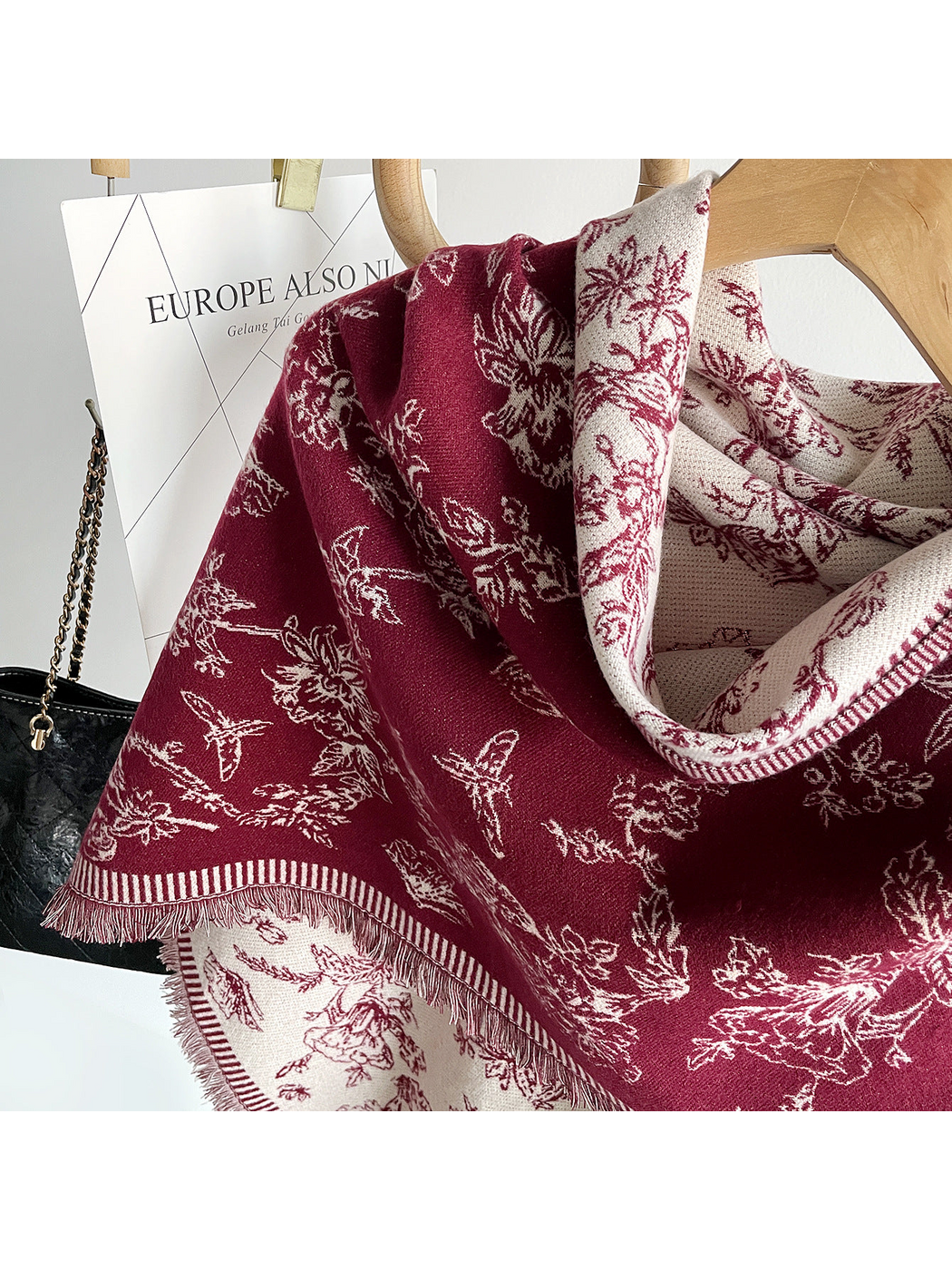 Burgundy floral scarf close-up showing cream reverse, striped border and fringe