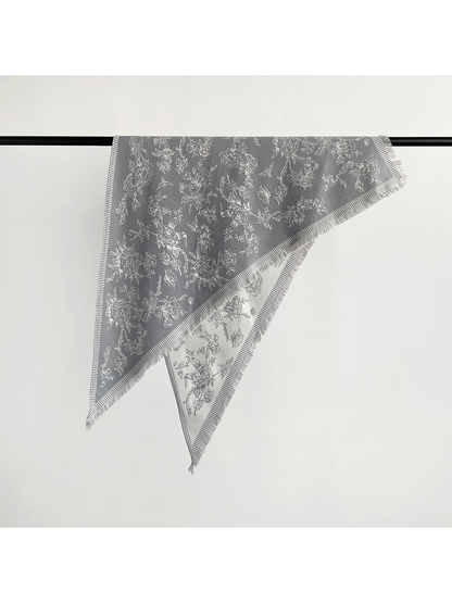 Gray floral triangle scarf with striped border, fringe and light reverse
