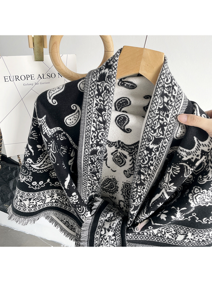 Black paisley scarf close-up showing contrasting faces, ornamental borders and fringe