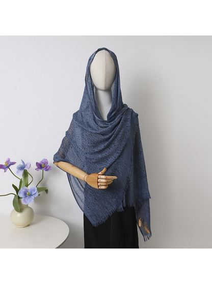 Navy scarf with scattered dots and short fringe draped over a mannequin
