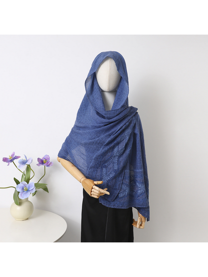 Blue scarf draped over a mannequin's head and shoulders