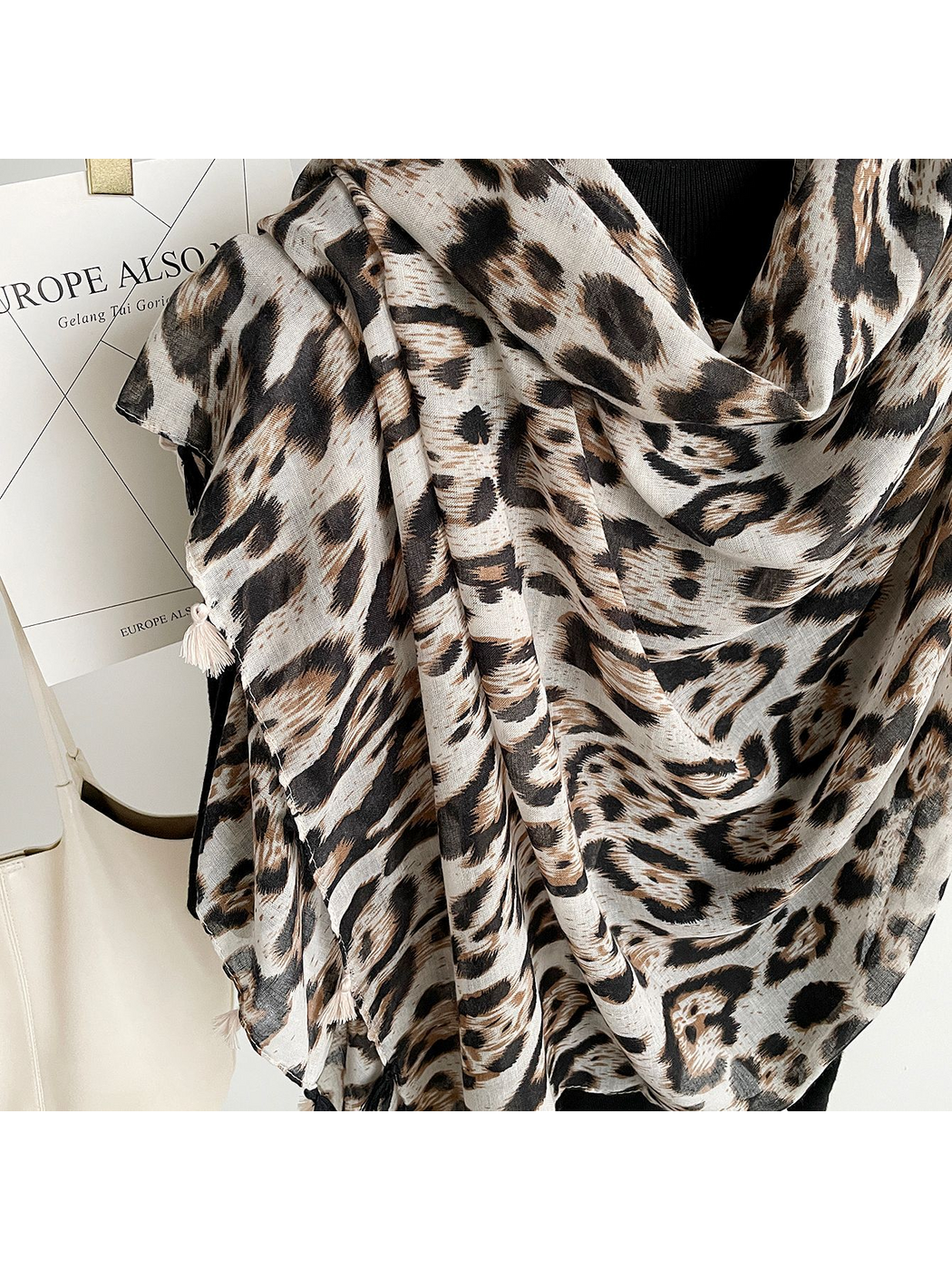 Close-up of Multicolor leopard-print scarf folds and tassels