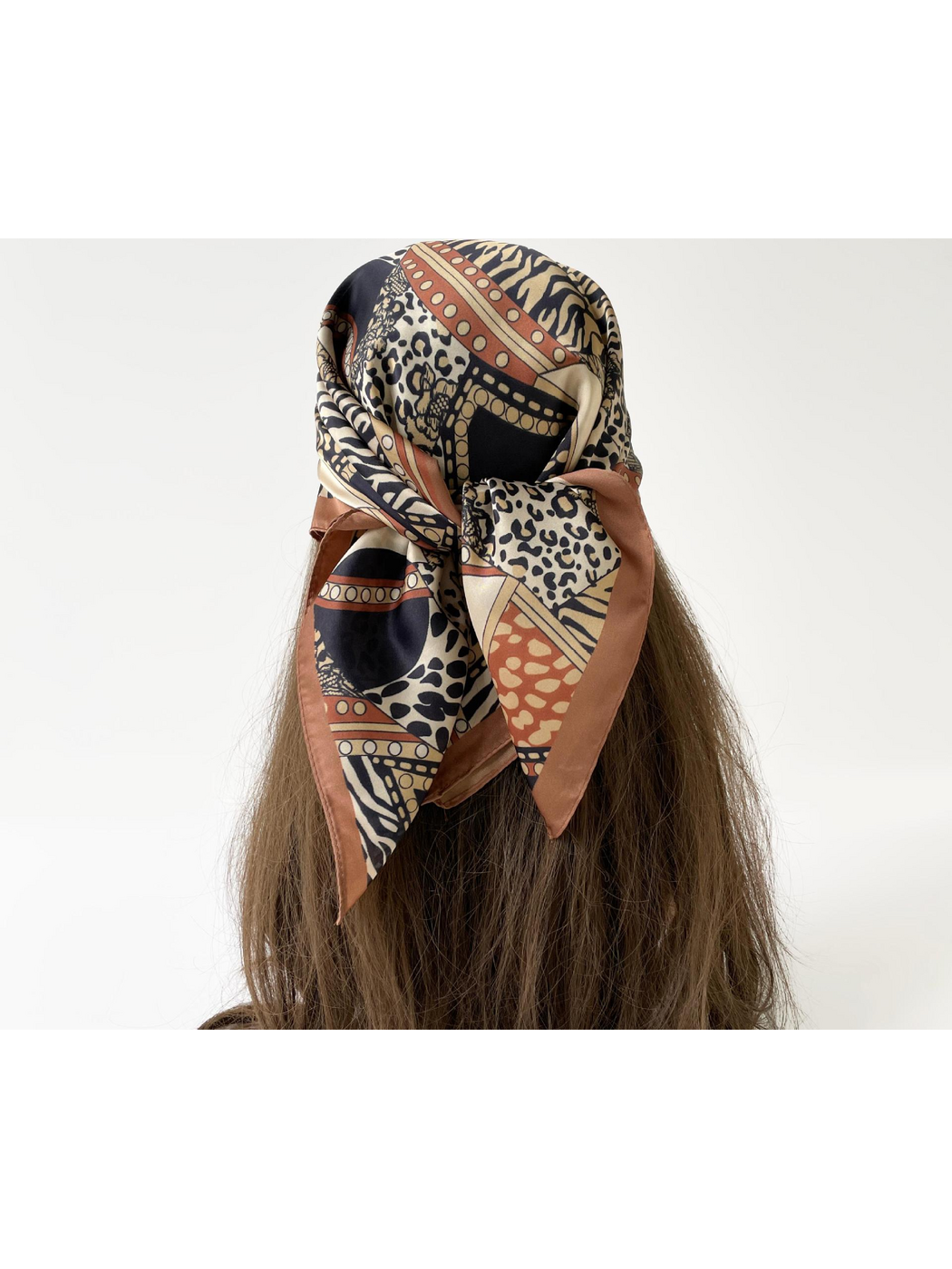 Orange animal-print scarf tied over the hair, rear view
