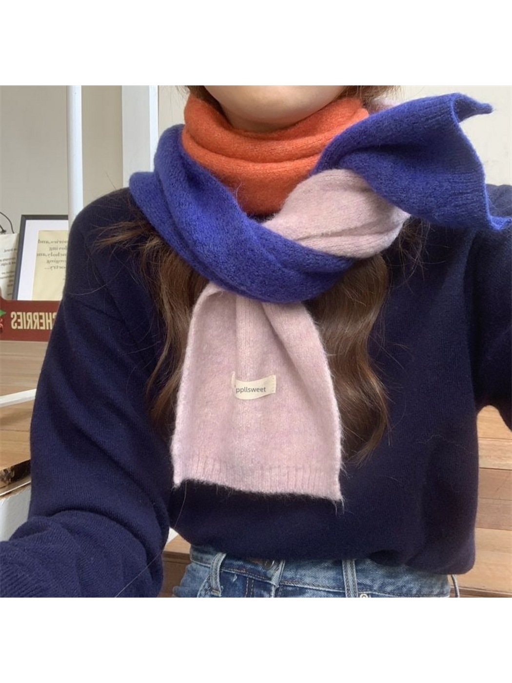 Blue color-block scarf wrapped around the neck, showing orange and purple sections