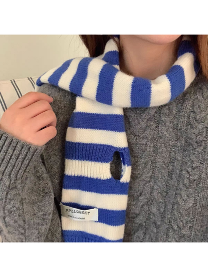 Blue striped knit scarf detail showing an elongated opening and fabric label