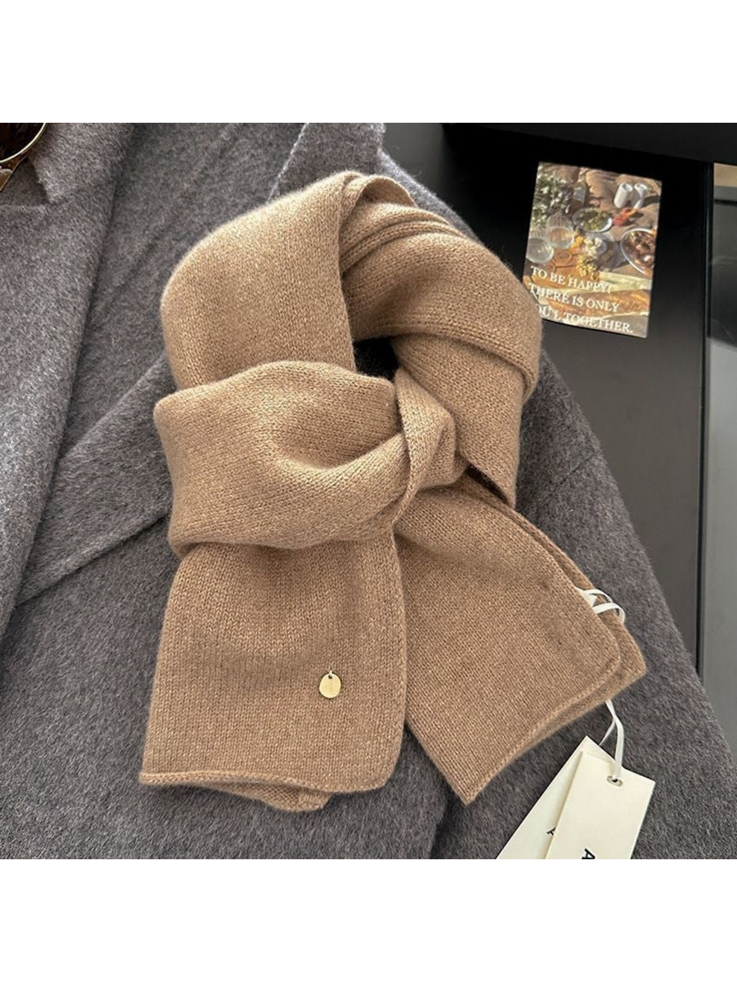 Camel scarf in a looped arrangement with plain finished ends and a round gold-tone disc