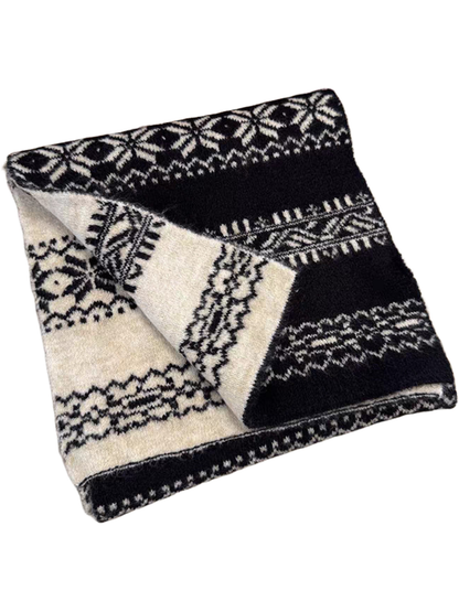 Black snowflake-pattern scarf folded to show its ivory reverse
