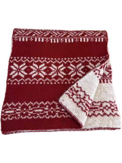 Red snowflake-pattern scarf folded with an ivory corner turned back