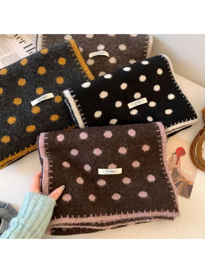 Folded polka dot scarves with light, pink and mustard-yellow accents displayed together