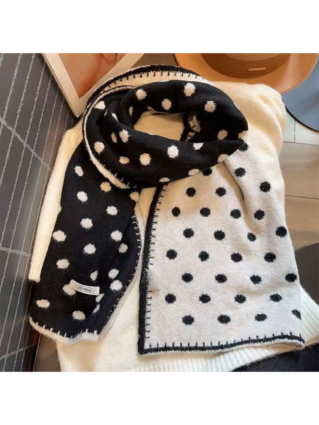 Polka dot scarf draped to show black and white contrasting faces and borders