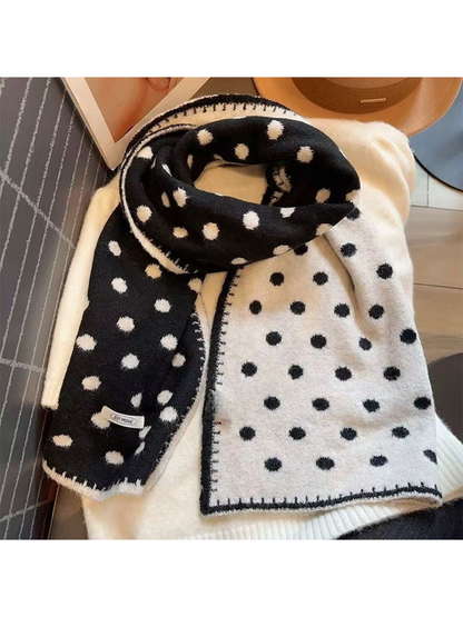 Polka dot scarf draped to show black and white contrasting faces and borders