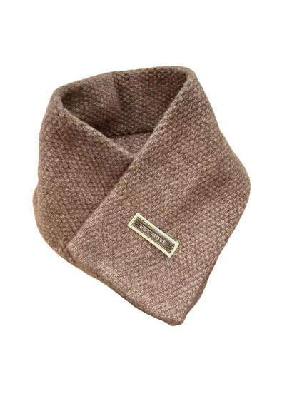 Brown textured crossover scarf with attached rectangular label on white