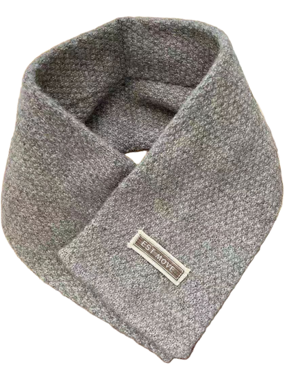 Gray textured crossover scarf with attached rectangular label