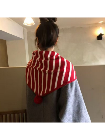 Red striped triangle scarf worn over a gray coat, rear view