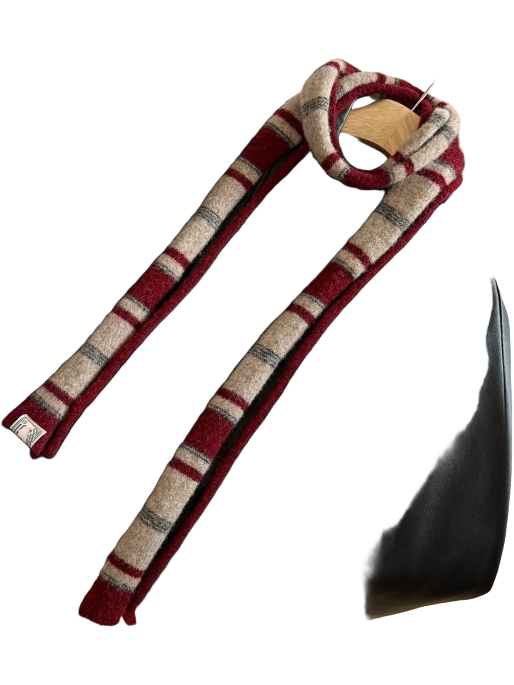 Burgundy striped scarf draped over a black jacket