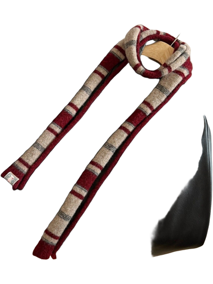 Burgundy striped scarf draped over a black jacket
