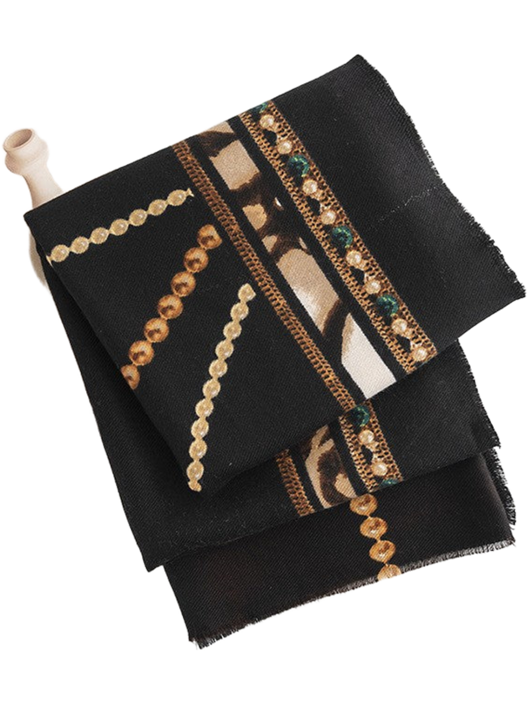 Black scarf folded in layers, showing gold-tone chain motifs, an ornamental border and short fringed edges