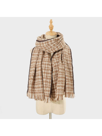 Brown plaid scarf with dark stitched edging and fringed ends, looped on a mannequin