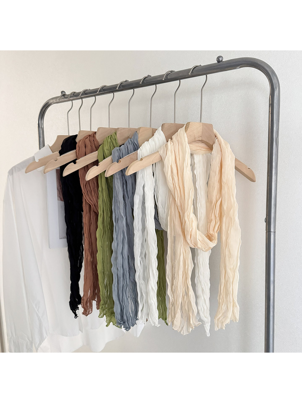 Crinkled scarves in several colors hanging together